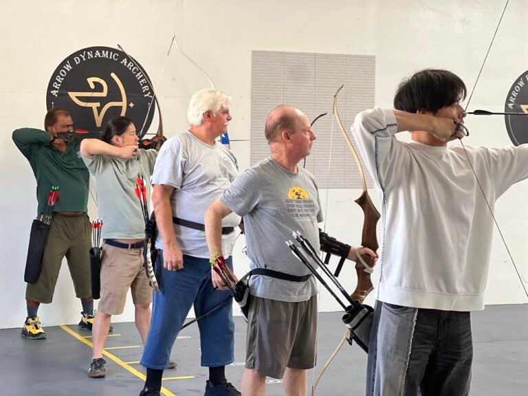 Adult archery class shooting with bows