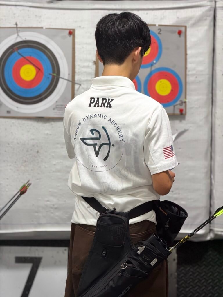 Teen standing next to a target