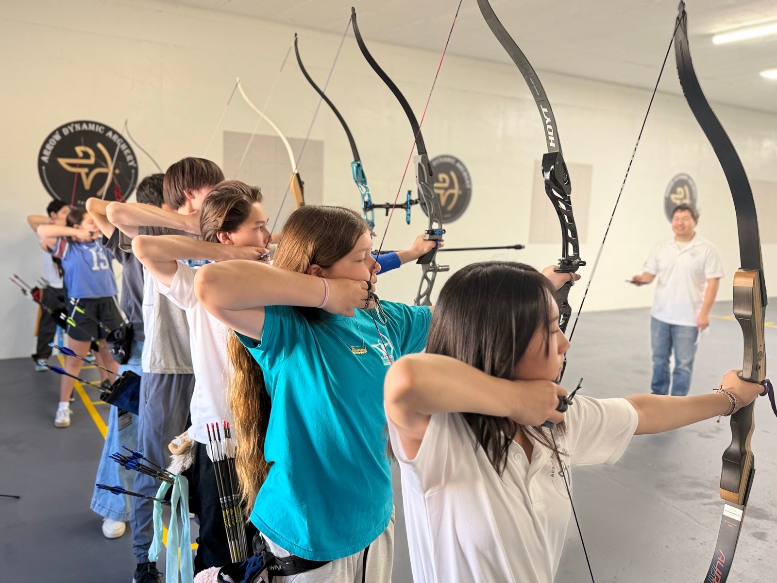 Young archers shooting on the line in an Explorers group class