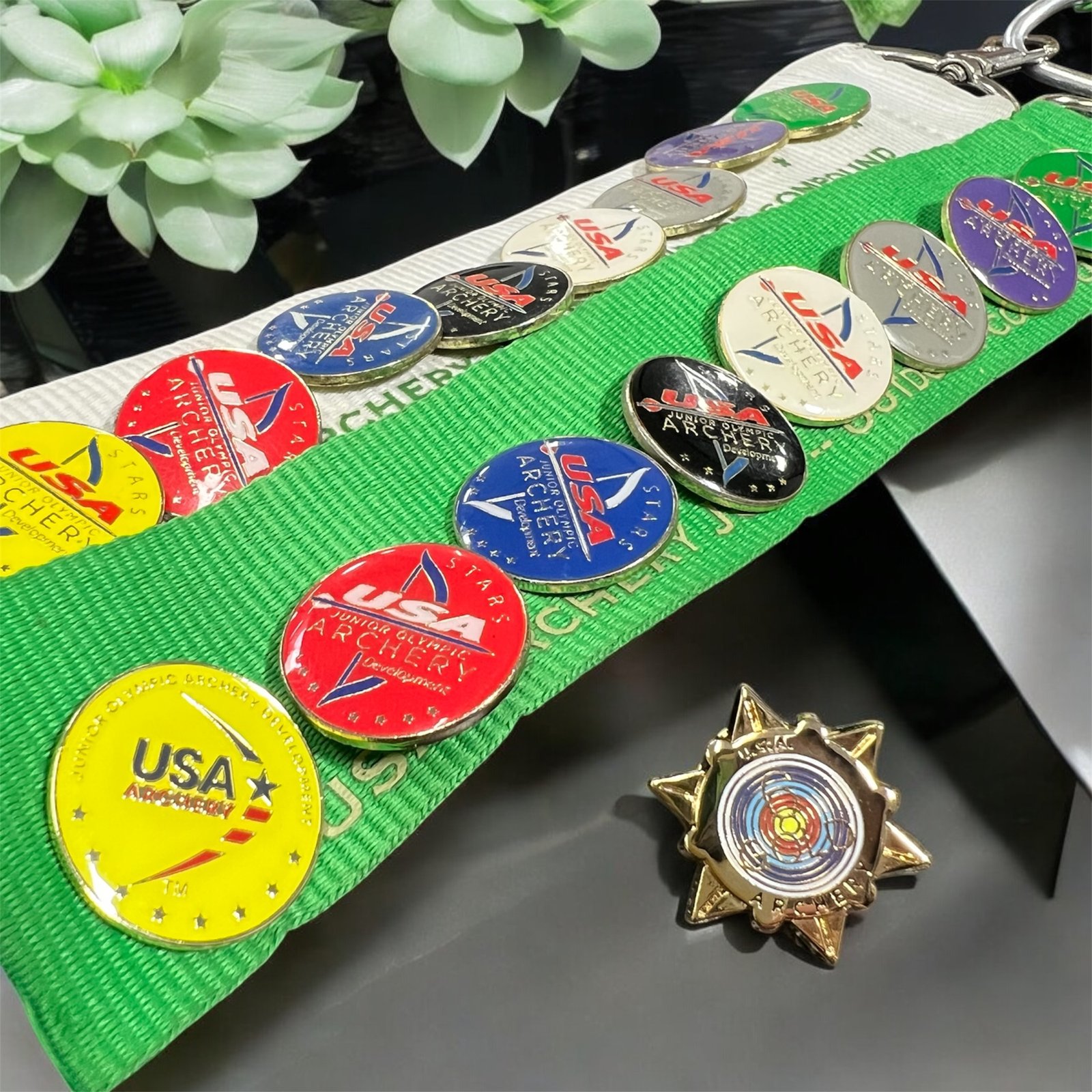 USA Archery Star achievement pins on an Arrow Dynamic Archery lanyard